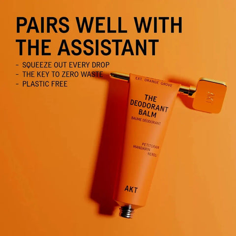 AKT The Deodorant Balm in Petitstar Mandarin Holio, presented on a vibrant orange background with promotional text.