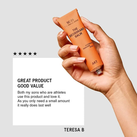 Hand holding an orange deodorant balm with a five-star rating and customer review on a light gray background