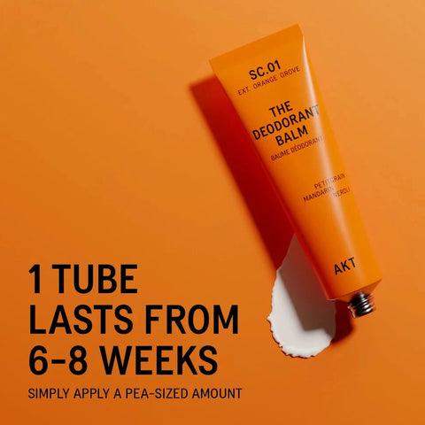 An orange tube of deodorant balm labeled 'THE DEODORANT BALM' and 'SC.01 EXT.