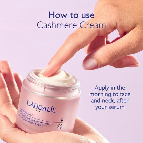 A hand scoops cream from a Caudalie Paris Cashmere Cream jar held in another hand, with text instructions on a soft lavender background.