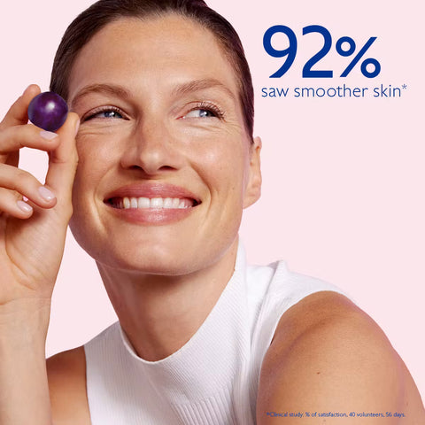 Woman holding a purple fruit with text indicating skin improvement on a pink background