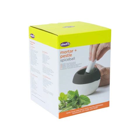 Chef's mortar and pestle spiceball box packaging, featuring a bright lime green top, white sides, and an image of hands using the white and dark gray mortar and pestle with mint leaves at the bottom.