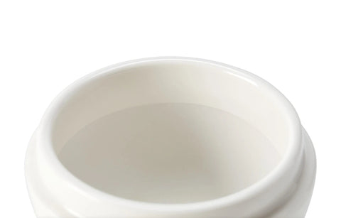 Close-up of the interior of a white ceramic cup or small bowl against a white background.