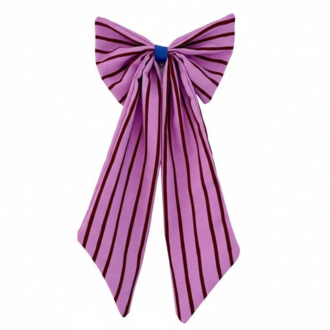 A pink satin bow with dark burgundy vertical stripes, tied at the center with a small blue ribbon accent, shown against a plain white background.