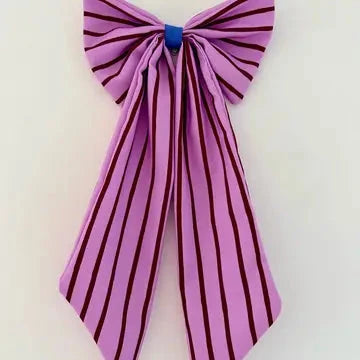 A pink satin bow with dark red vertical stripes, tied at the top with a small blue ribbon, shown against a plain white background.