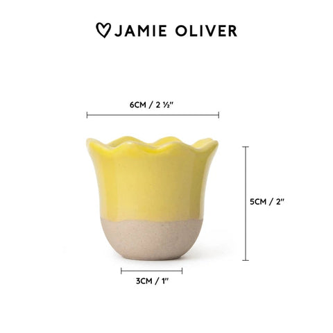 Yellow and beige ceramic cup with dimensions and 'Jamie Oliver' branding on a white background
