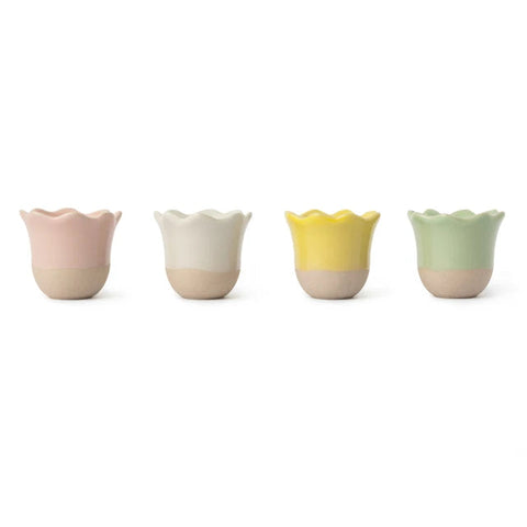 Set of four colorful ceramic cups on a white background