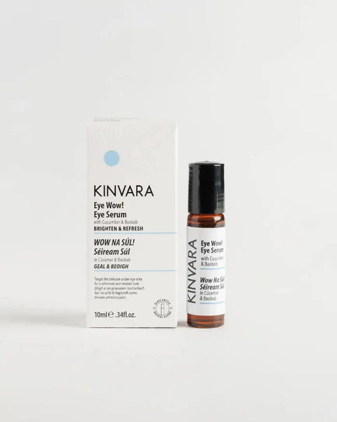 KINVARA Wow! Wow! Eye Serum in a 10ml amber glass bottle with a black cap, standing next to its white cardboard packaging box on a clean white background.
