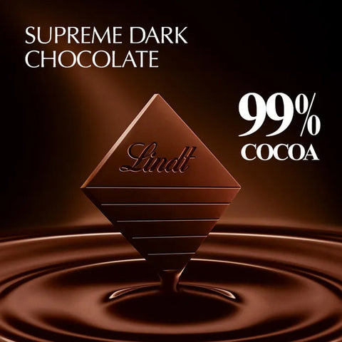 A single Lindt chocolate bar shaped like a diamond, labeled 'Supreme Dark Chocolate 99% Cocoa,' shown floating above a glossy pool of chocolate on a dark brown background.