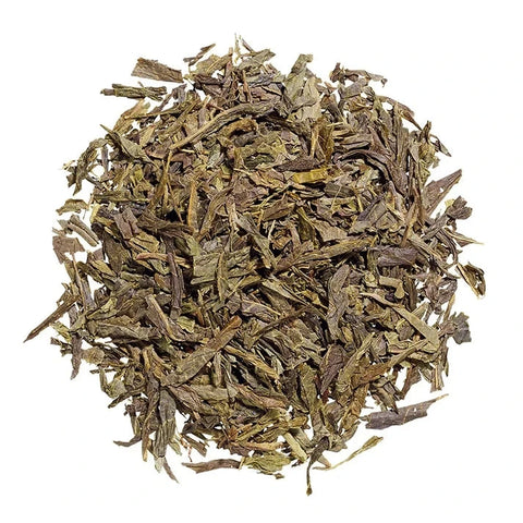 A pile of dried loose-leaf tea leaves, showing shades of olive green, brown, and tan, isolated on a solid white background.