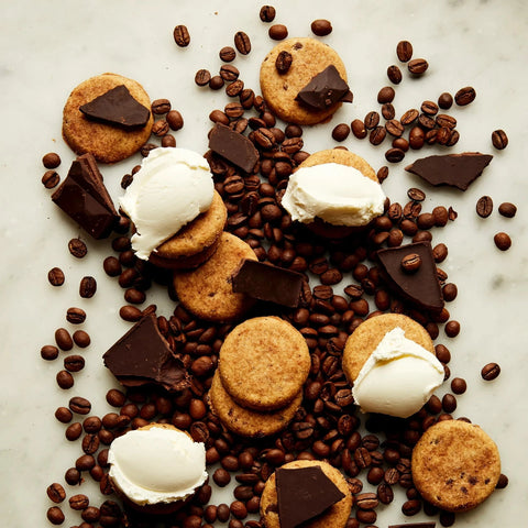 Cookies, ice cream, and coffee beans arranged on a marble surface