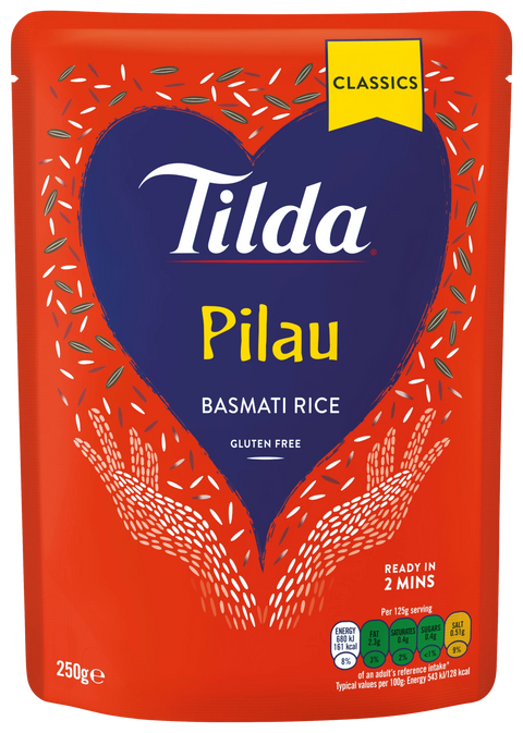 A 250g stand-up pouch of Tilda Pilau Basmati Rice, Classics flavor. The packaging features a bright red background with a large dark blue heart in the center containing the white Tilda logo and yellow 'Pilau' text.